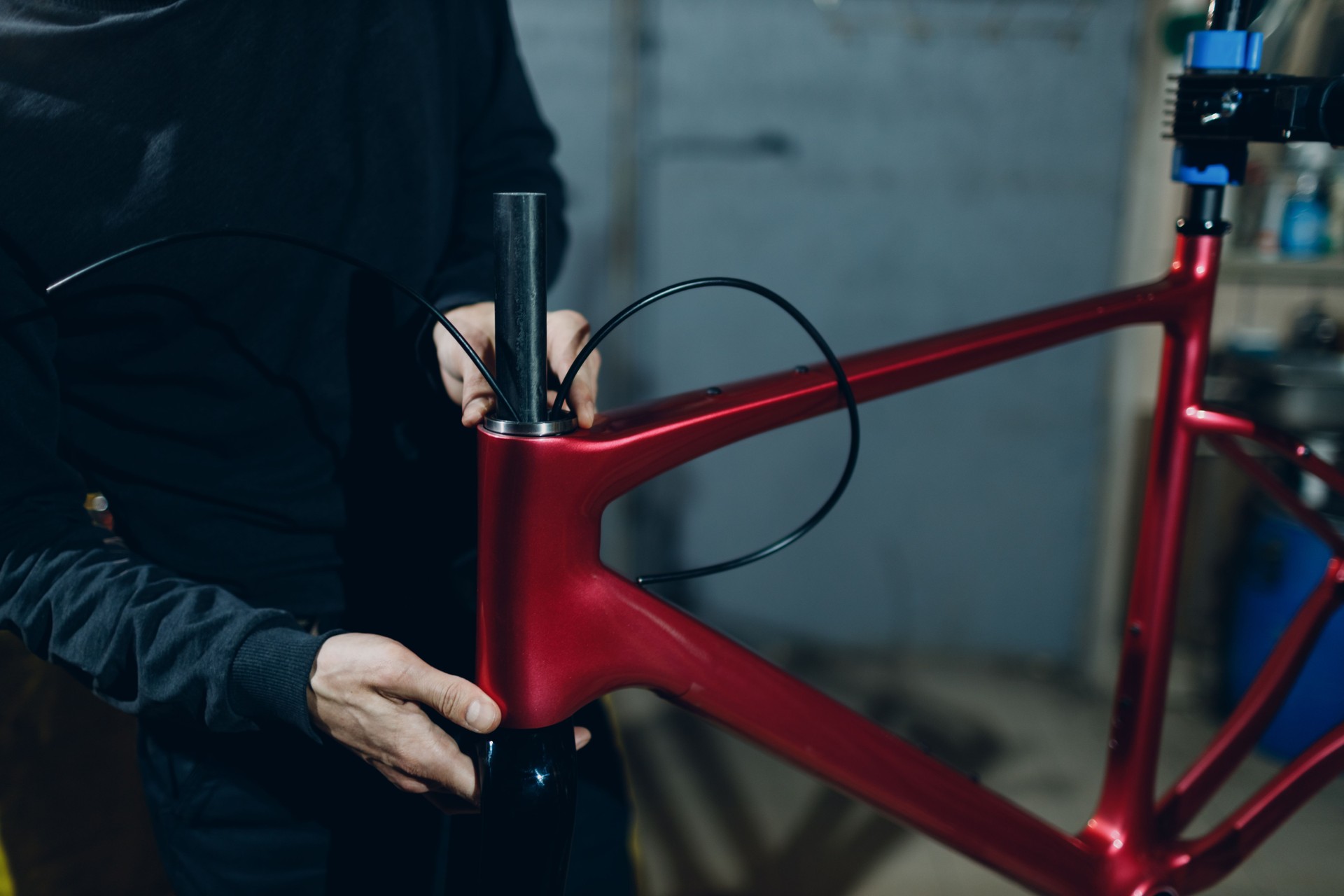 Mechanic repairman assembling custom bicycle brake cables in workshop