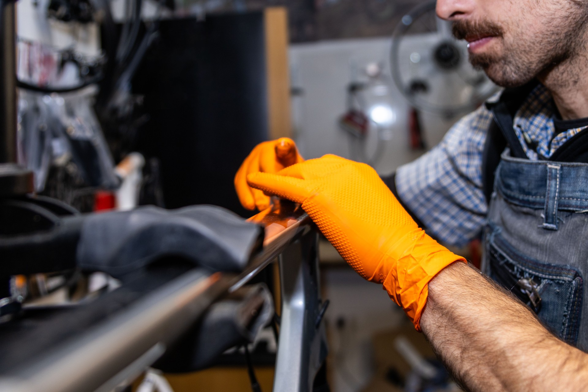 Bicycle mechanic repairing a bike frame in workshop